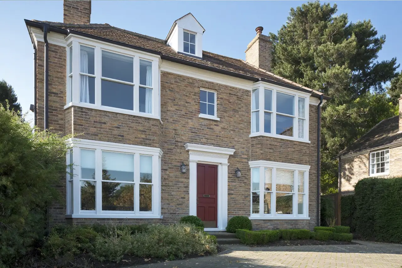 Brick semi with new white casement windows fitted across the front elevation