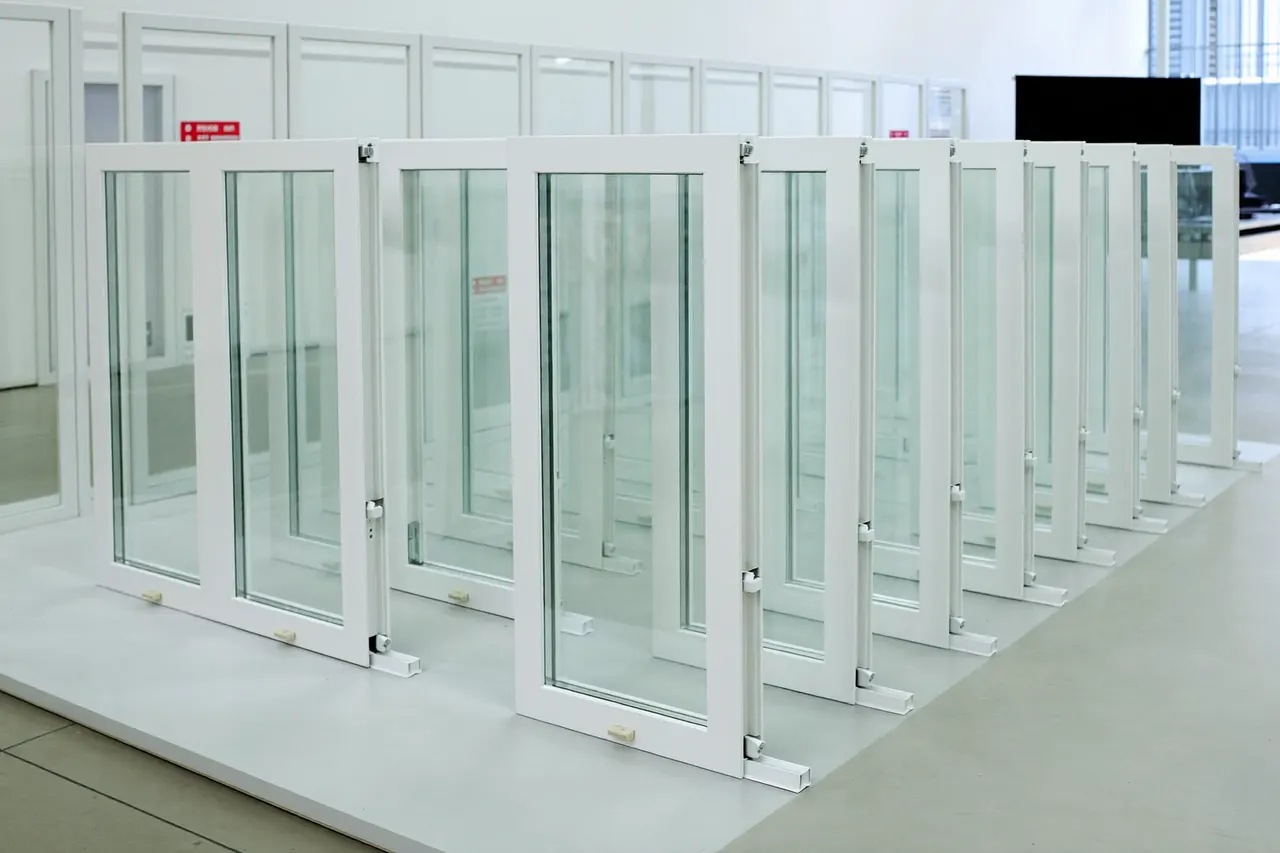 Row of white uPVC casement window samples in a showroom