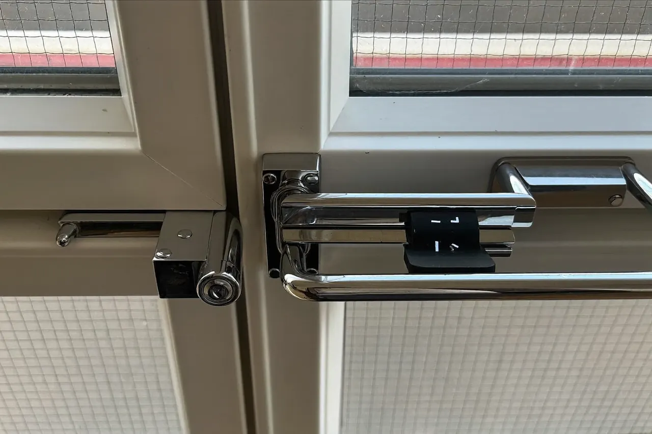 Detail of a window handle and locking point on a newly fitted frame